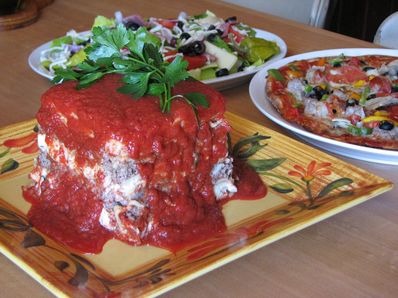Homemade lasagna with pizza and an antipasto salad